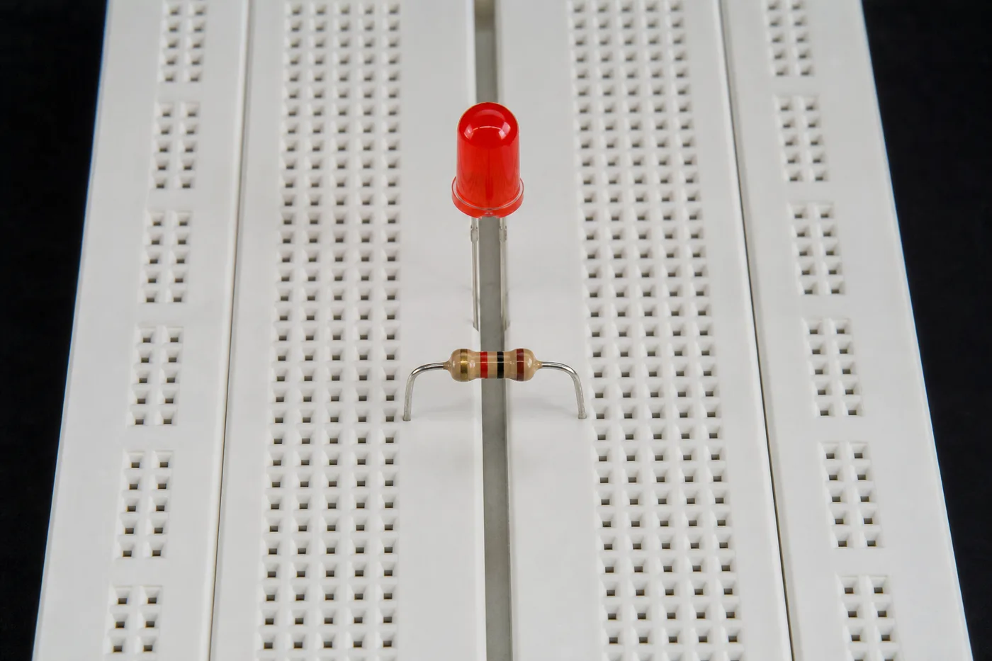 Vertical component connections on a breadboard with LED and resistor Vertical component connections on a breadboard with LED and resistor